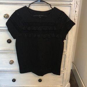 Black tee with eyelet and tassel details!